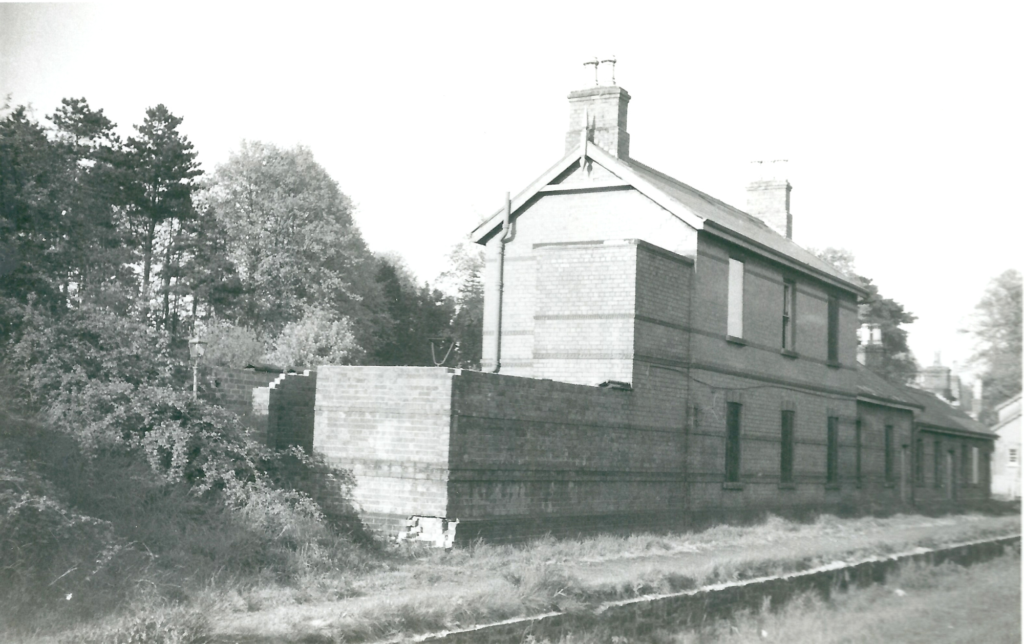 Neill's Hill Railway Station prior to demolition. Two storey building, station platform and railway tracks in an unused state.